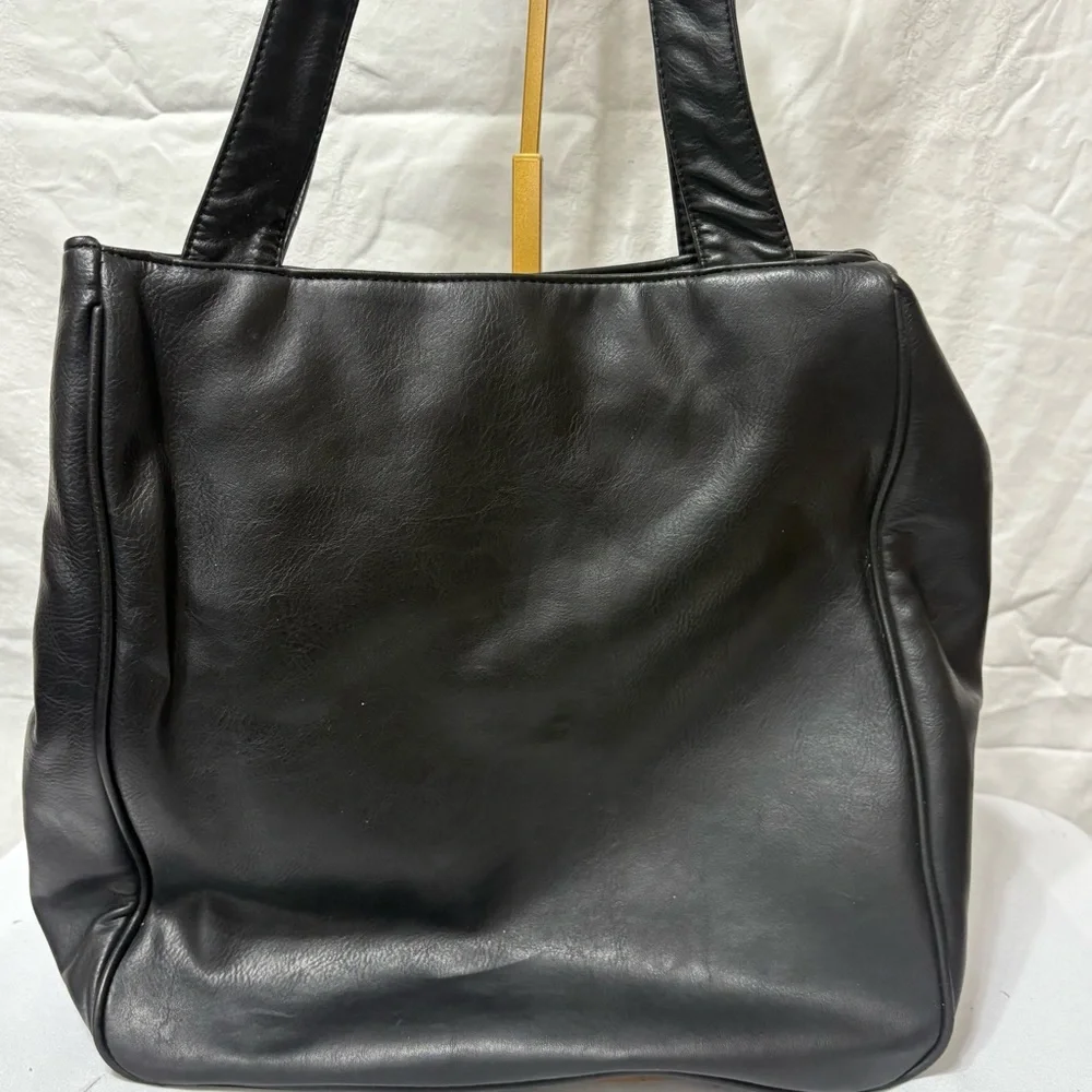 Black tote bag with a tassel accent. - Picture 5 of 12